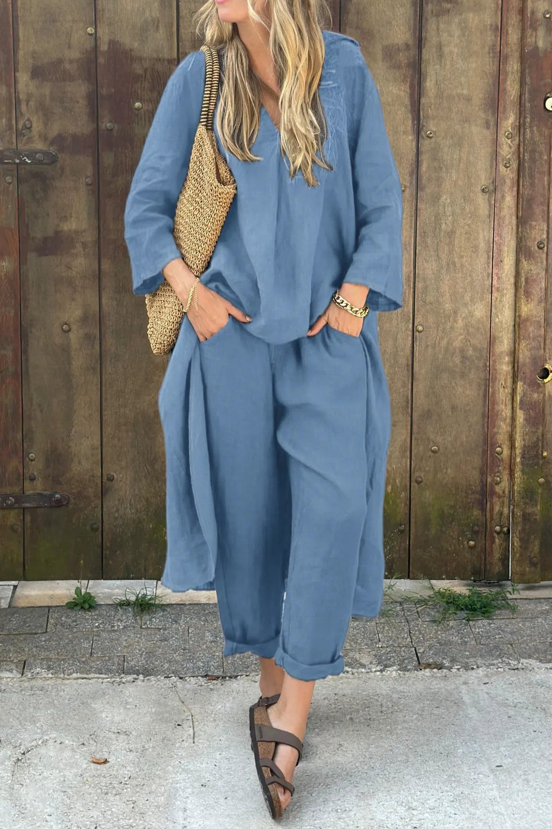 Side profile of a woman wearing a white relaxed fit tunic and pant set