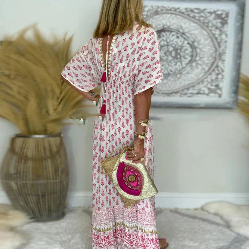 Relaxed fit women's maxi dress in vibrant boho print. Features a stylish v-neck and short sleeves for summer.