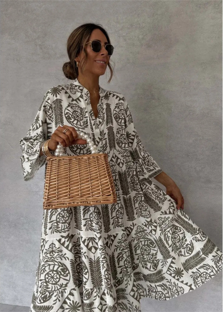 Stylish women's printed midi dress with a unique boho pattern, oversized flowy design, long sleeves, and elegant stand collar.
