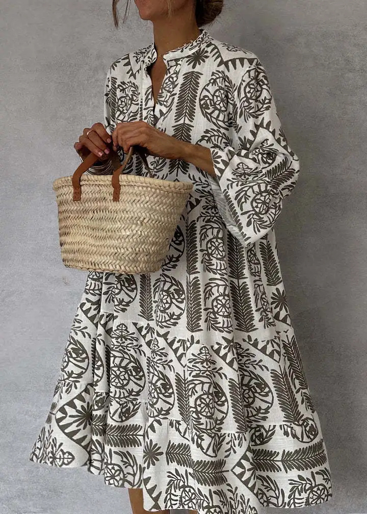 Statement women's fashion midi dress featuring an eye-catching boho print, oversized, flowy design, and long sleeves.