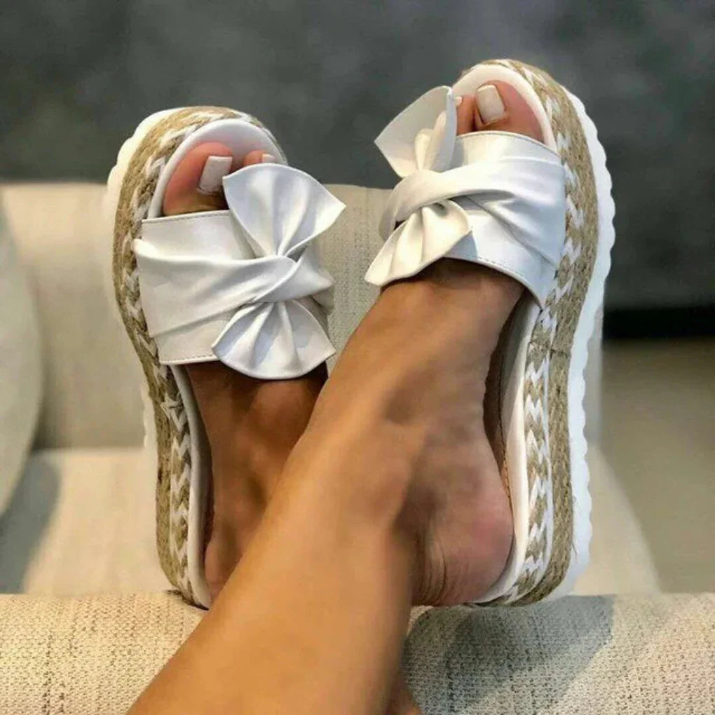 Fashionable women's bow platform sandals in a neutral color, great for versatile summer styling