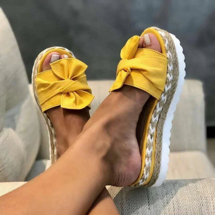 Chic women's platform slides with a decorative bow detail, designed for ultimate comfort and style