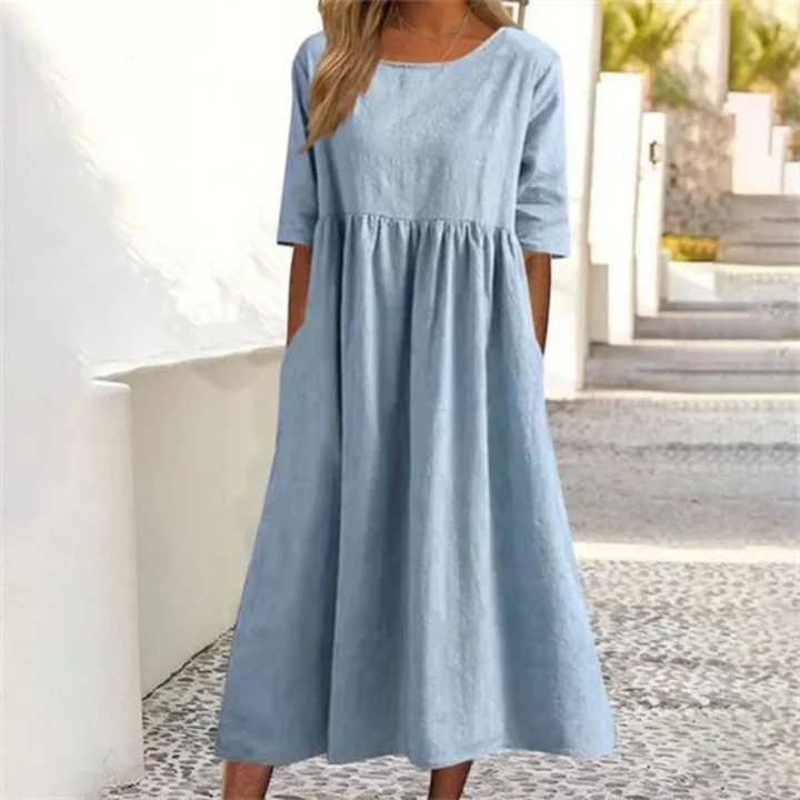 Women's breezy smocked-waist midi dress with short sleeves, perfect for summer comfort and style.