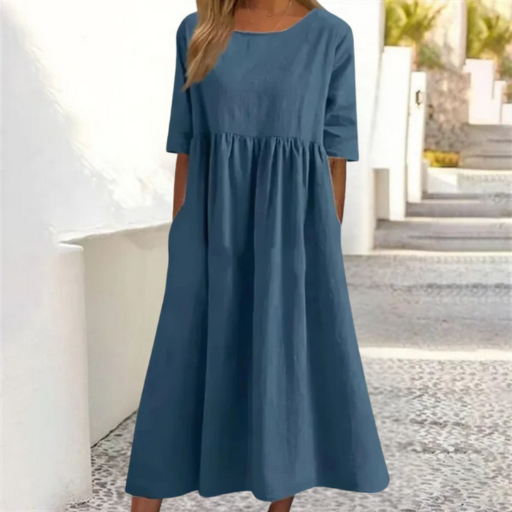 Casual A-line summer midi dress for women, featuring a smocked waist, short sleeves, and pockets.