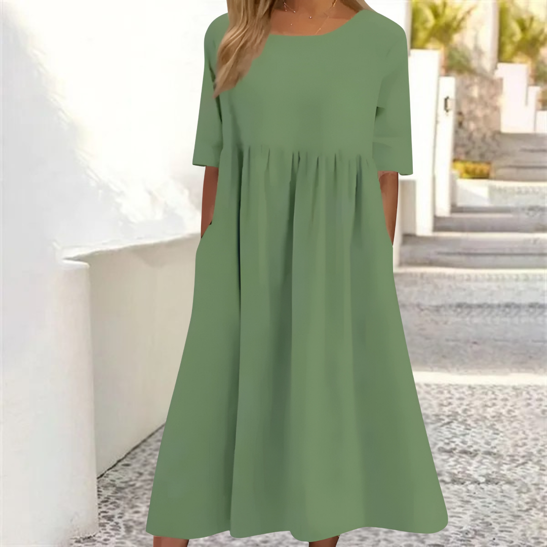 Women's smocked-waist summer midi dress with short sleeves and convenient pockets for casual wear.