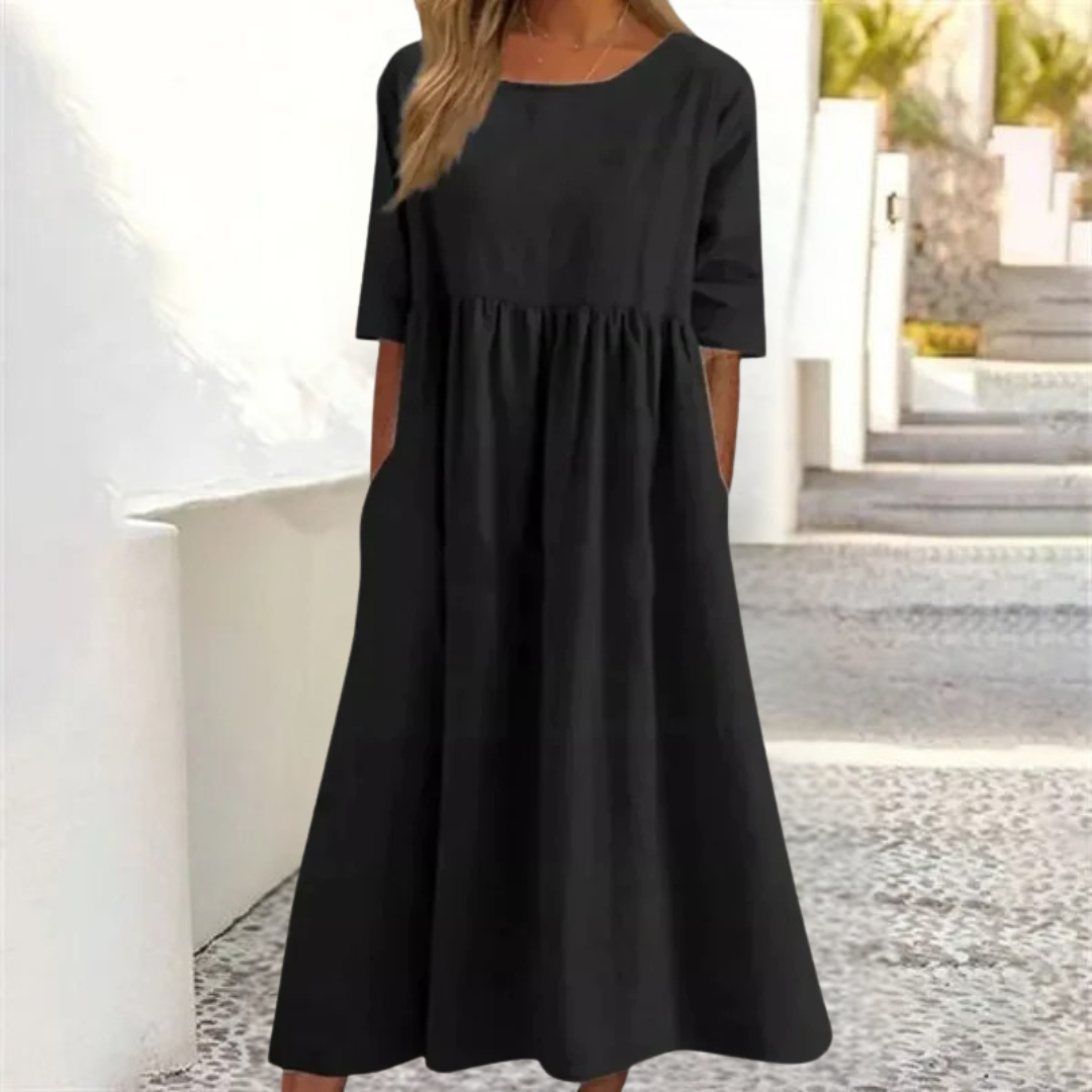 Stylish women's A-line summer midi dress, breezy fabric, smocked waist, short sleeves for warm days.