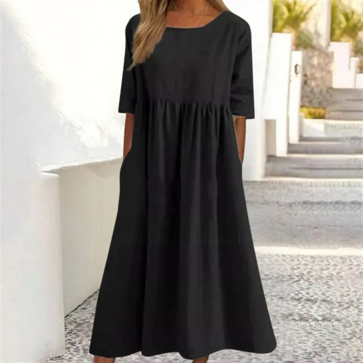 Stylish women's A-line summer midi dress, breezy fabric, smocked waist, short sleeves for warm days.