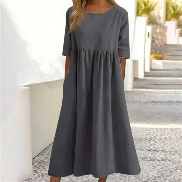 Elegant yet casual women's smocked-waist midi dress, short sleeve, breezy for summer outings.