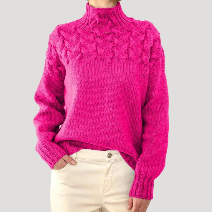 Front view of a women's high-neck cable knit sweater in navy blue, comfortable and stylish knitwear.
