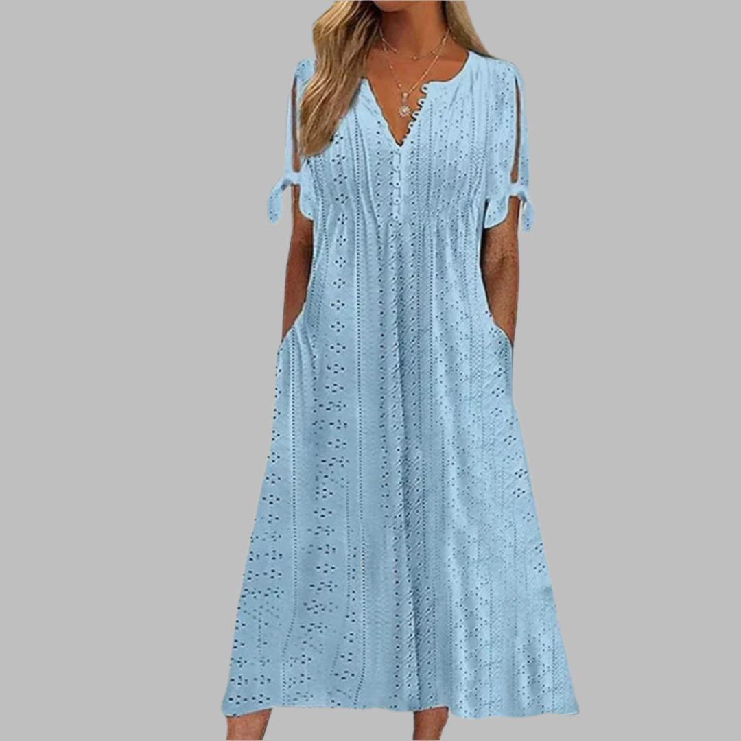 White eyelet midi dress for women, boho casual style with a flattering V-neck, A-line cut, and functional pockets.