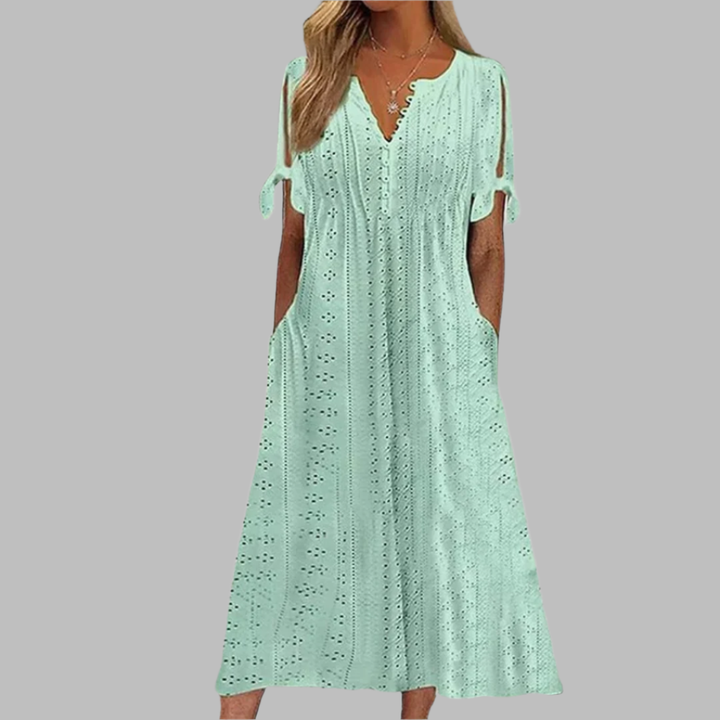Stylish women's summer midi dress, white eyelet fabric, boho V-neck, A-line silhouette, and chic tie-sleeves.