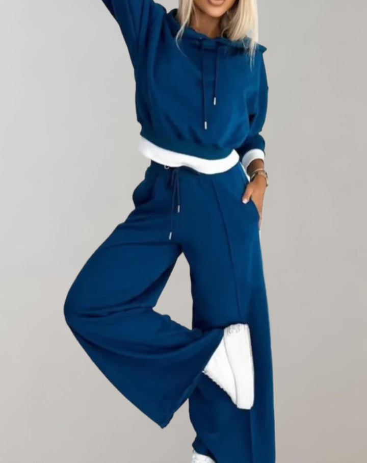 Matching set for women: a casual hoodie and tracksuit pants, offering a comfortable and stylish outfit.