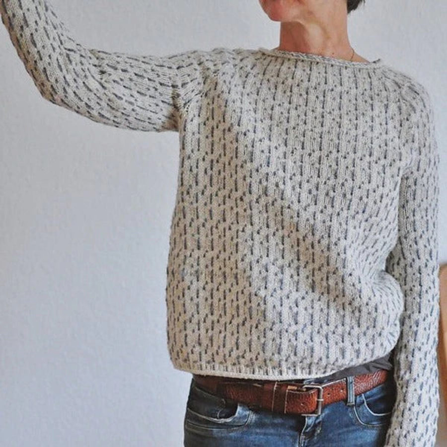Versatile grey knit sweater with a boat neck, offering a chic and casual look for women.
