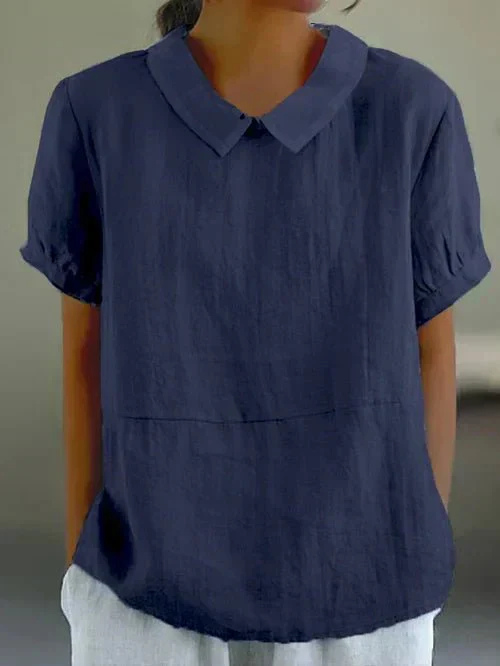 Elegant women's casual blouse featuring a classic Peter Pan collar. Short sleeve, relaxed fit, feminine top.