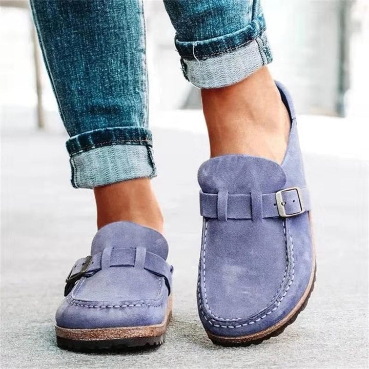 Close-up of a women's casual loafer showing the buckle detail and comfortable slip-on design.