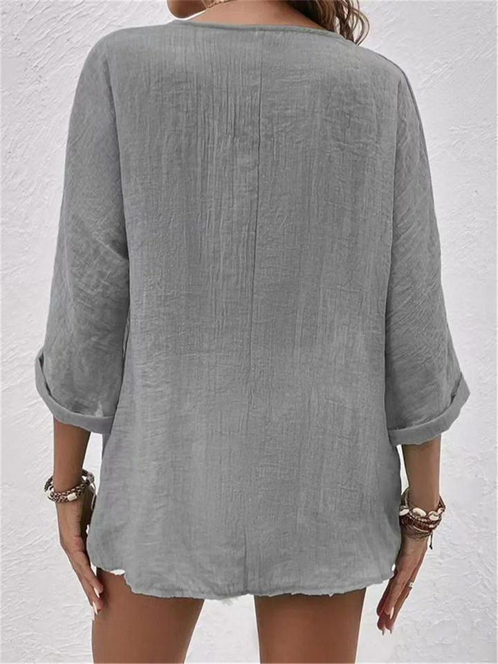 Relaxed fit women's casual V-neck button-front top, ideal for comfortable and stylish everyday outfits.