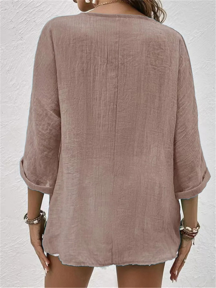 Chic women's V-neck three-quarter sleeve button-front shirt for elegant yet casual everyday wear.