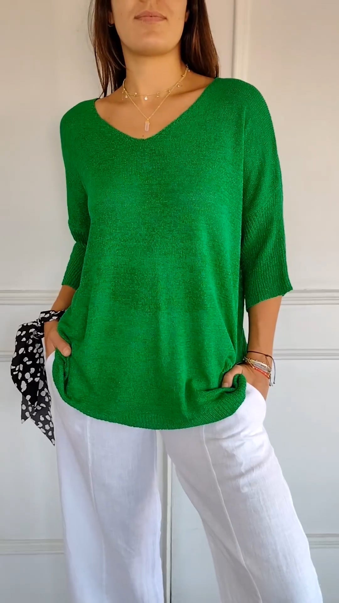 Chic women's casual V-neck top with three-quarter sleeves and a relaxed, comfortable fit.