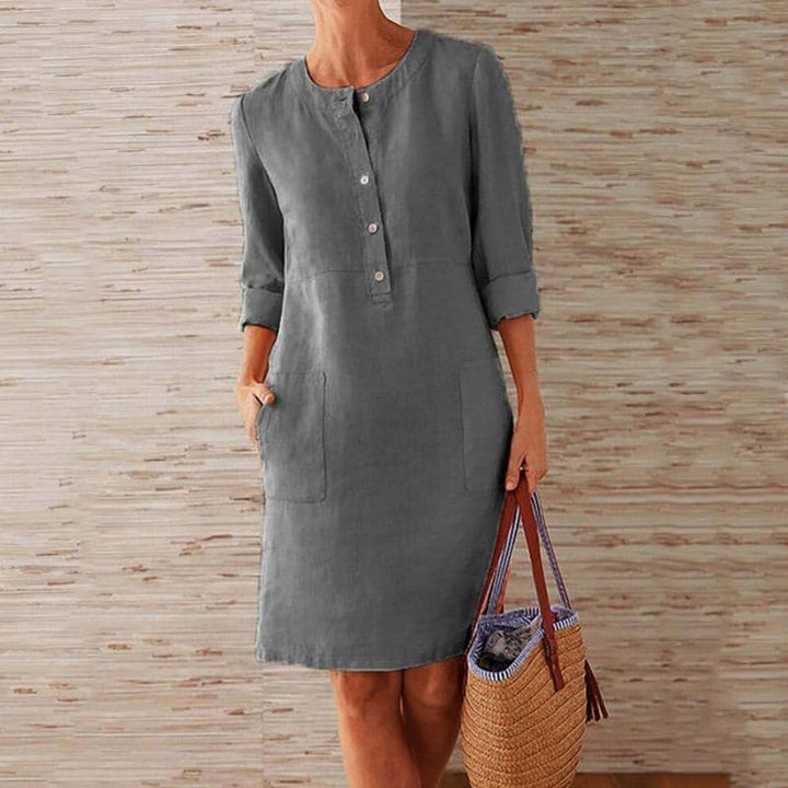 Stylish women's casual shift dress with button-front detail, 3/4 sleeves, and functional side pockets.