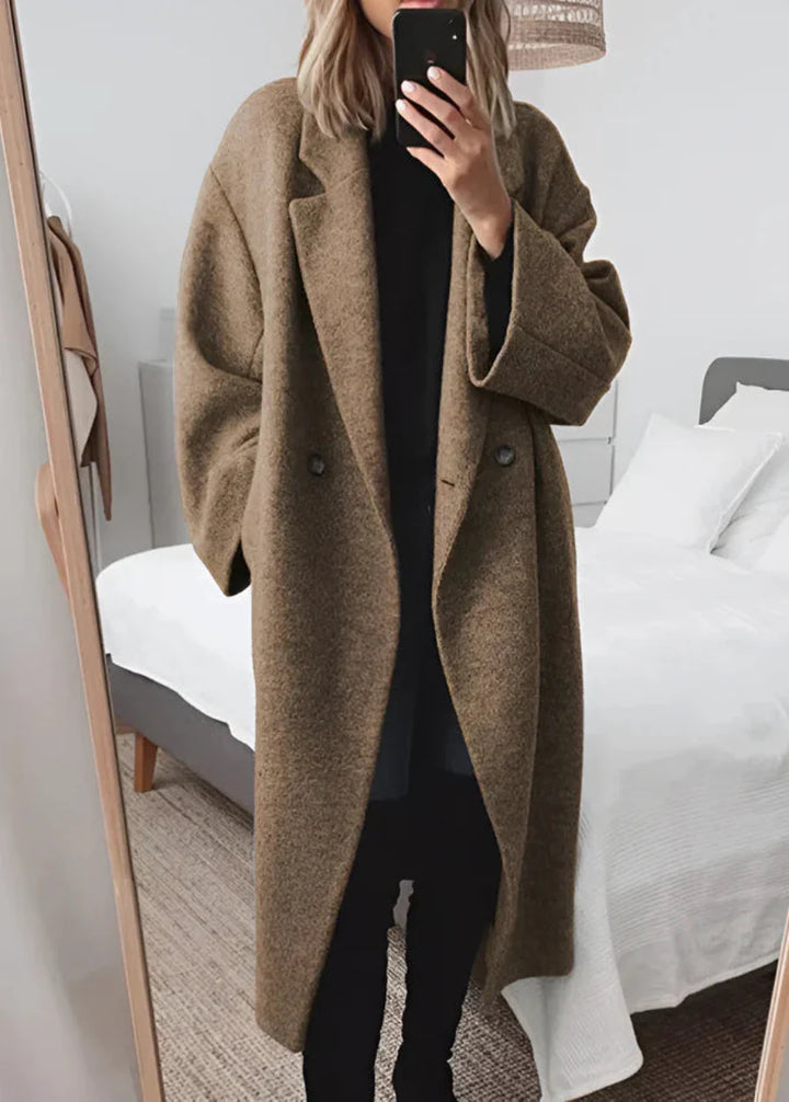 Fashionable women's oversized long coat. Versatile maxi outerwear for chic winter style & comfort.