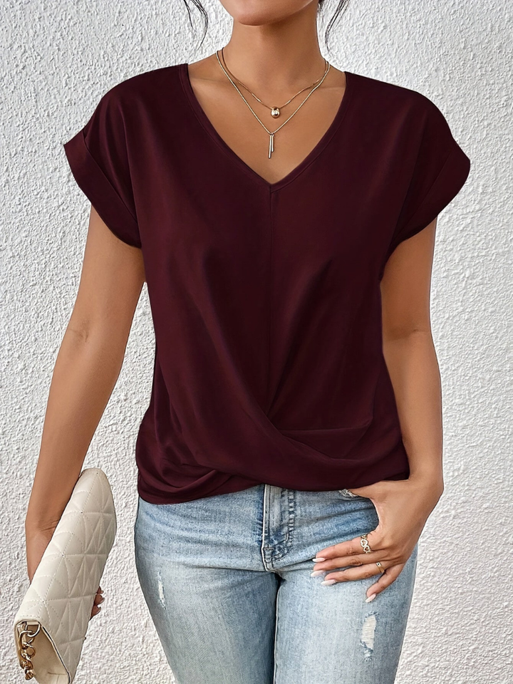 Versatile women's fashion top with a polished twist-front, V-neck, and short sleeves. Ideal for day to night.