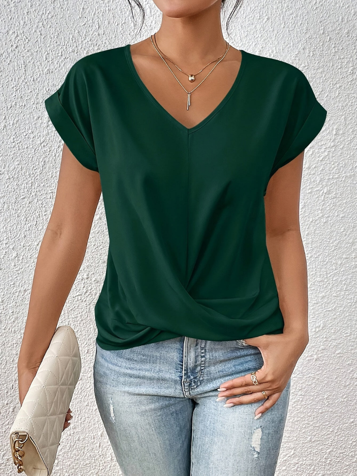 Modern women's twist-front short sleeve top. Chic V-neck blouse designed for an elegant, sophisticated fashion statement.