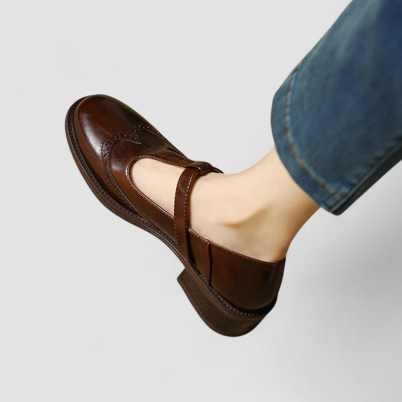 Top-down view of women's black mary jane flats, highlighting the rounded toe and buckle