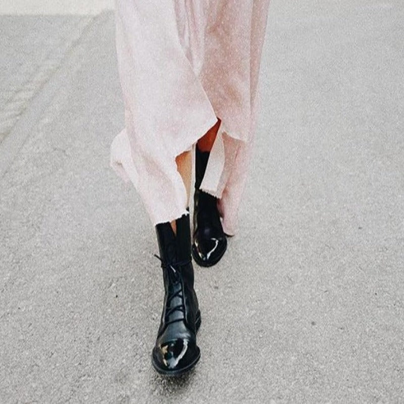 Classic black combat boots for women, featuring a lace-up design and durable construction for everyday wear.