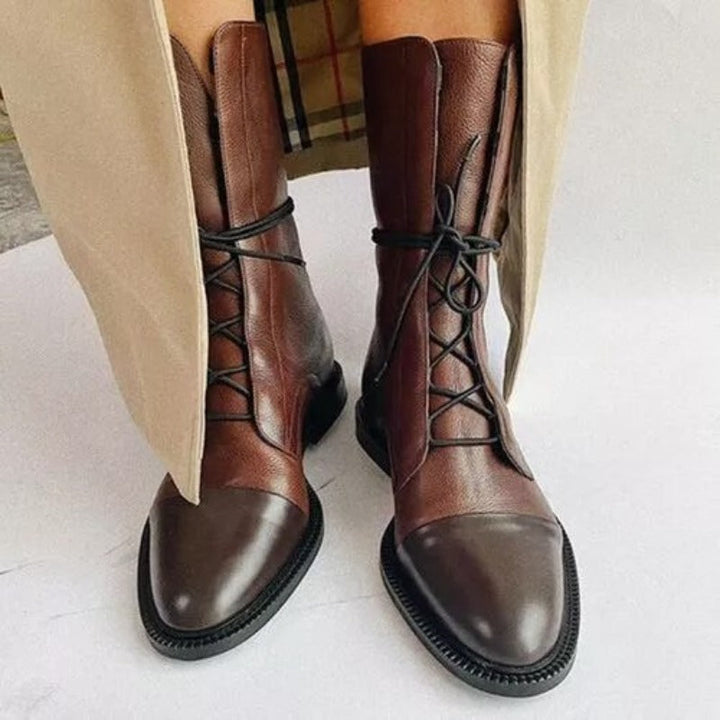 Durable women's combat boots, black with lace-up detail, a classic and versatile choice for any season.