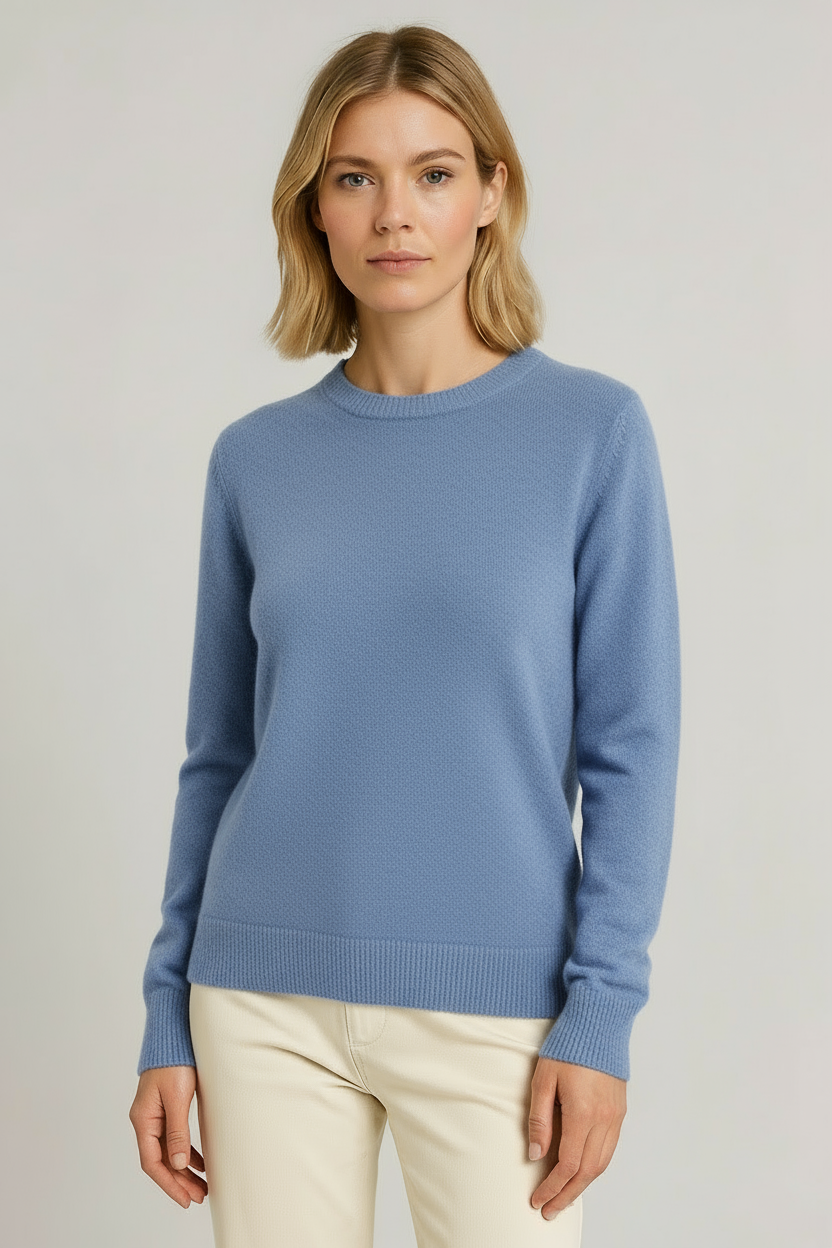 Close-up of soft women's crew neck knit sweater, offering cozy comfort & classic appeal.