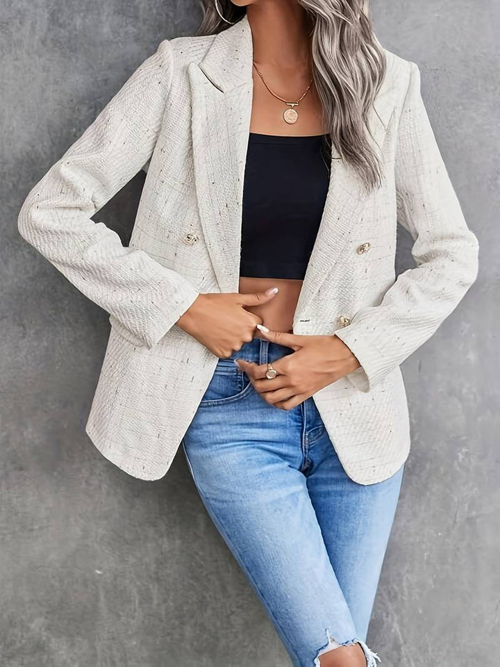 Chic women's tailored beige blazer, double-breasted design, ideal for professional or elegant everyday wear.