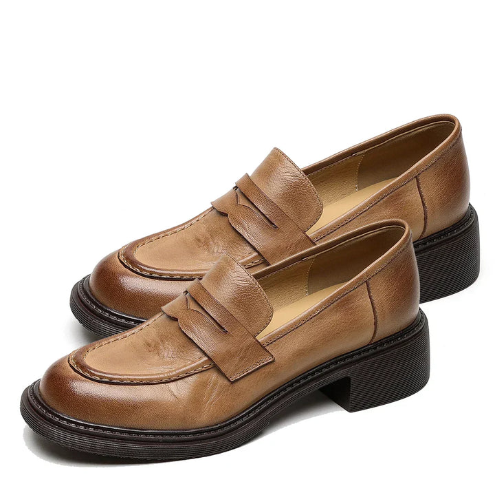 Light brown leather T-strap flats for women, a comfortable and classic dress shoe perfect for any occasion.