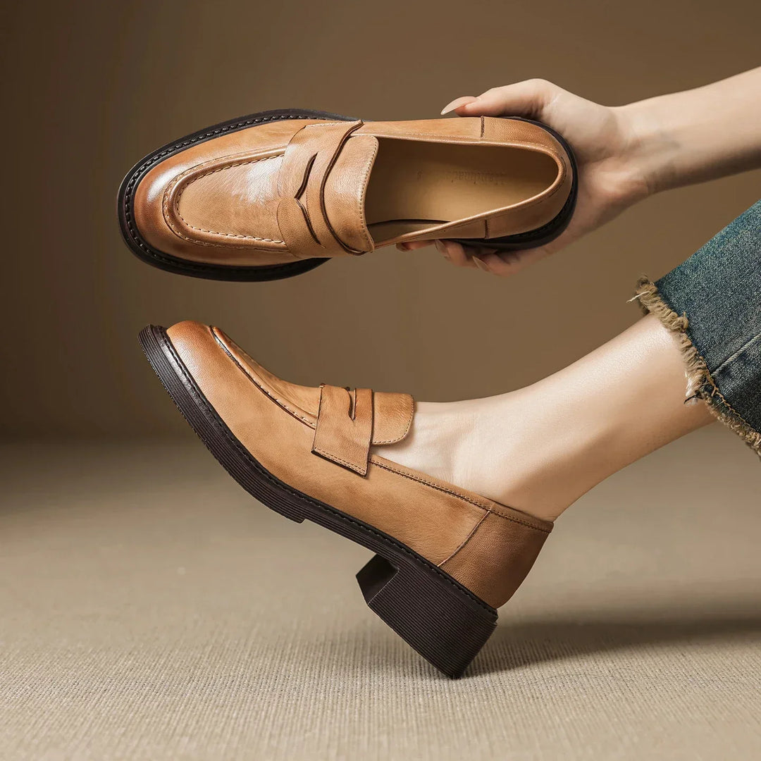 Elegant women's T-strap leather shoes in light brown, offering comfort and classic style as a versatile flat.