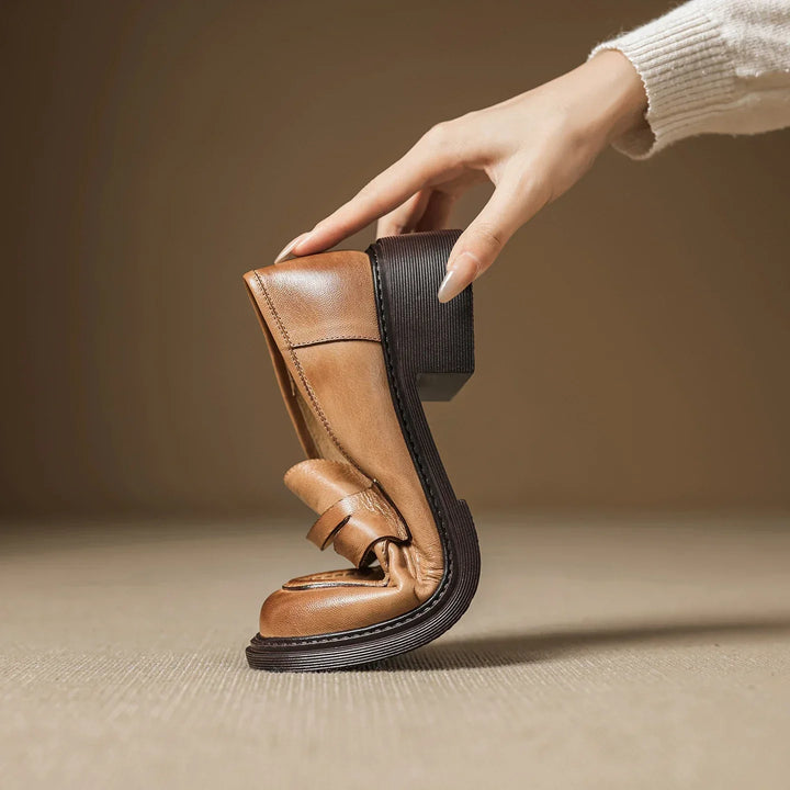 Classic women's dress shoes: light brown leather T-strap flats, designed for comfort and timeless elegance.