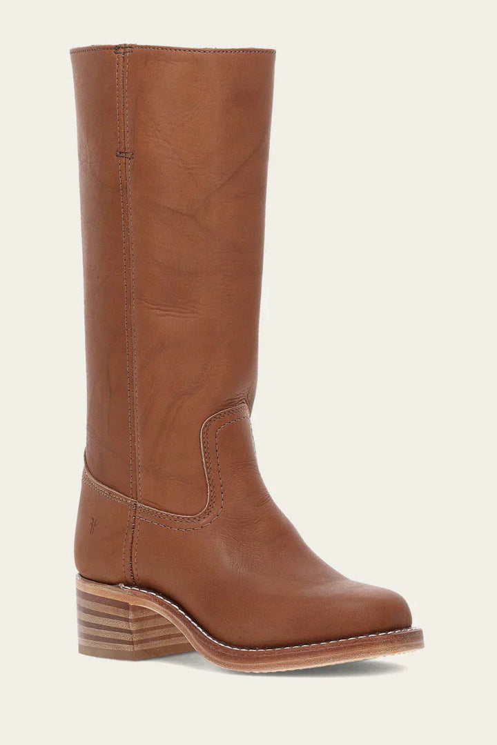 Front view of women's sleek silver buckle detail on a black mid-calf western boot, embracing fashion trends
