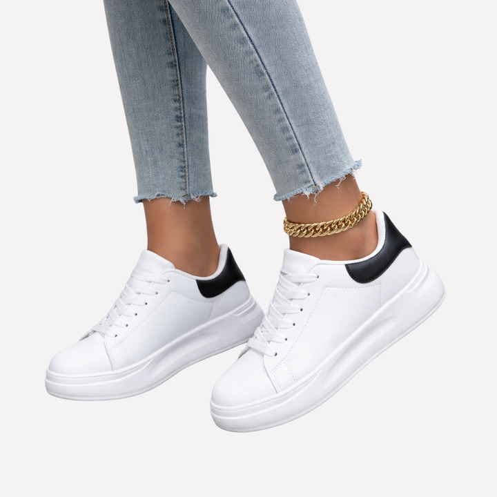 Women's clean white casual sneakers, perfect for everyday wear & minimalist style. Comfortable low-top fashion footwear.
