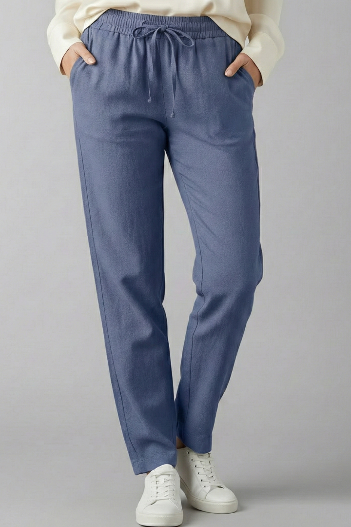 Relaxed fit women's trousers featuring elastic waist, side pockets & stylish tapered leg.