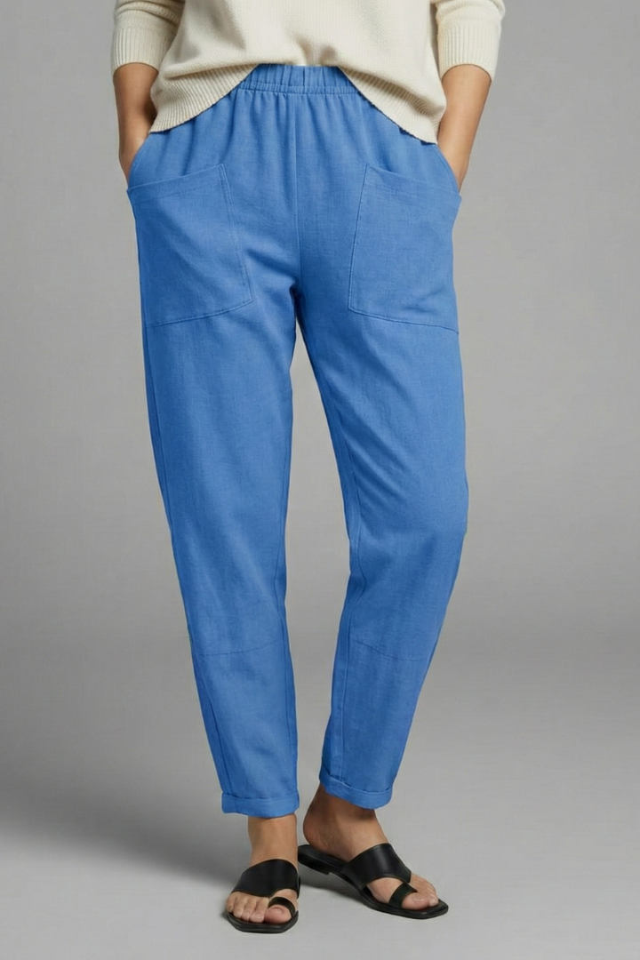 Front view: Women's tapered trousers with elastic waist, practical side pockets & ankle length.