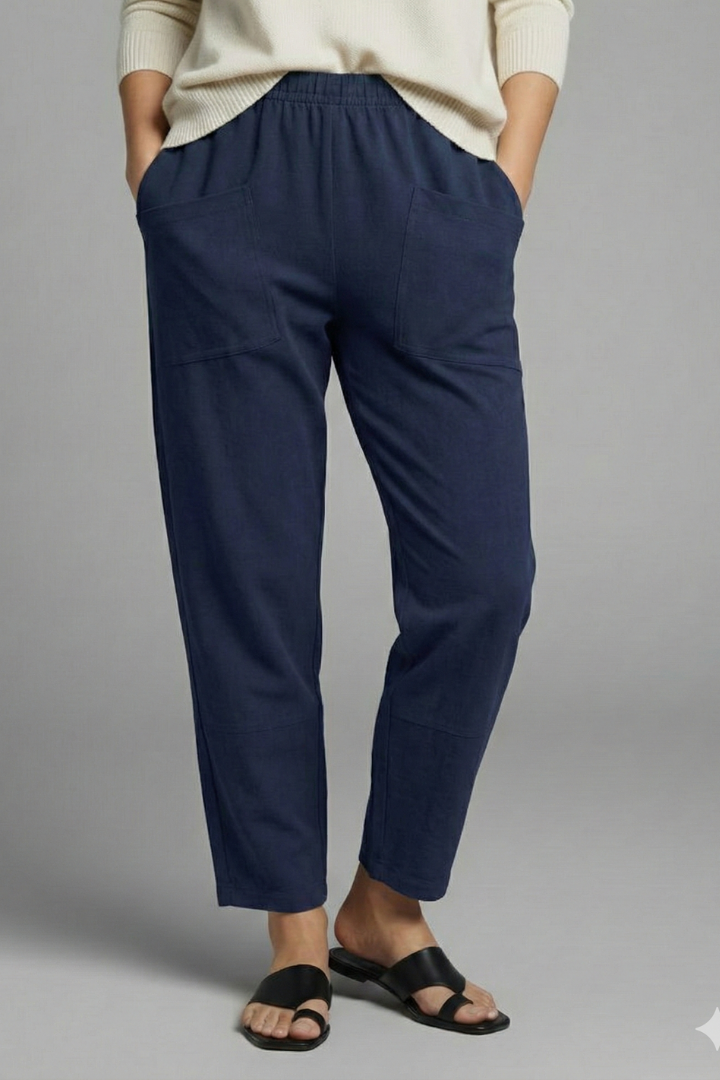 Detail of practical side pockets on women's comfortable tapered ankle-length trousers.