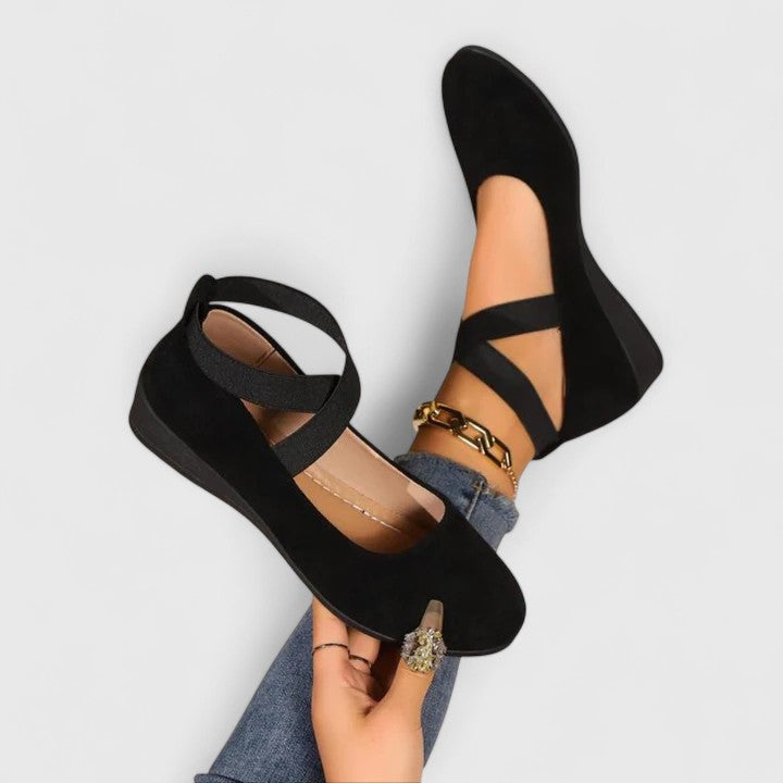 Everyday women's closed-toe wedge sandals with secure elastic crossover straps, offering comfort for all-day wear.
