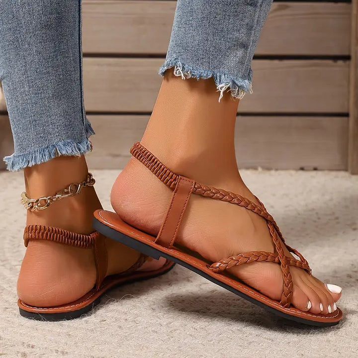 Easy-to-wear women's flat sandals with elastic straps, perfect slip-on casual footwear for summer days.