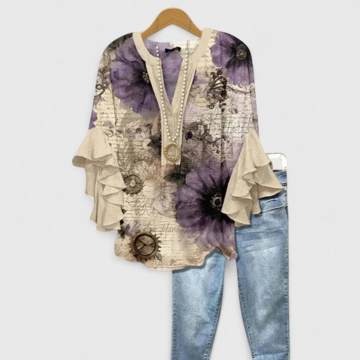 Beautiful women's floral blouse with elegant ruffle sleeves. Comfortable, versatile top for spring & summer everyday wear.
