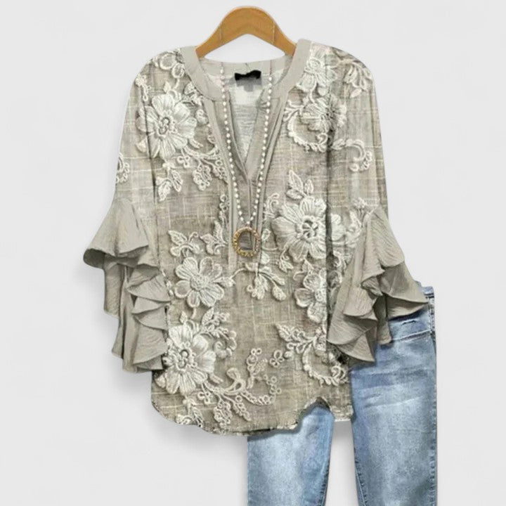 Chic women's floral ruffle sleeve blouse offering a comfortable fit for everyday elegance. Versatile spring/summer top.