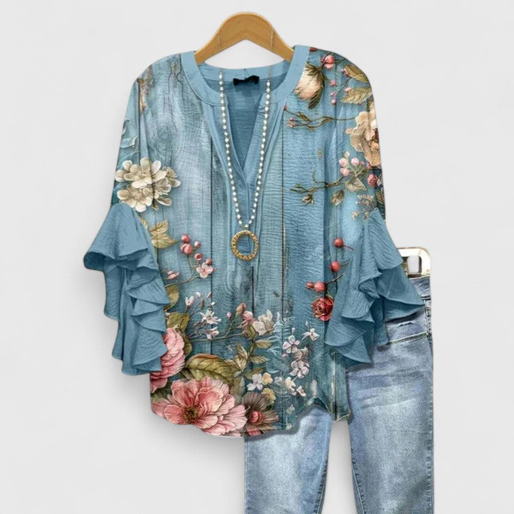 Stylish women's floral blouse with delicate print & flattering ruffle sleeves. Casual chic and comfortable for spring.