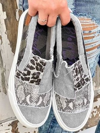 Side view of women's canvas leopard print slip-on shoes, highlighting the low profile and stretch fit