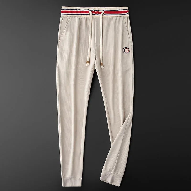 Soft ribbed women's joggers with a flexible stretch fit & trendy striped waistband. Perfect for athleisure.