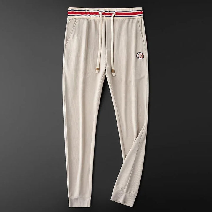 Soft ribbed women's joggers with a flexible stretch fit & trendy striped waistband. Perfect for athleisure.