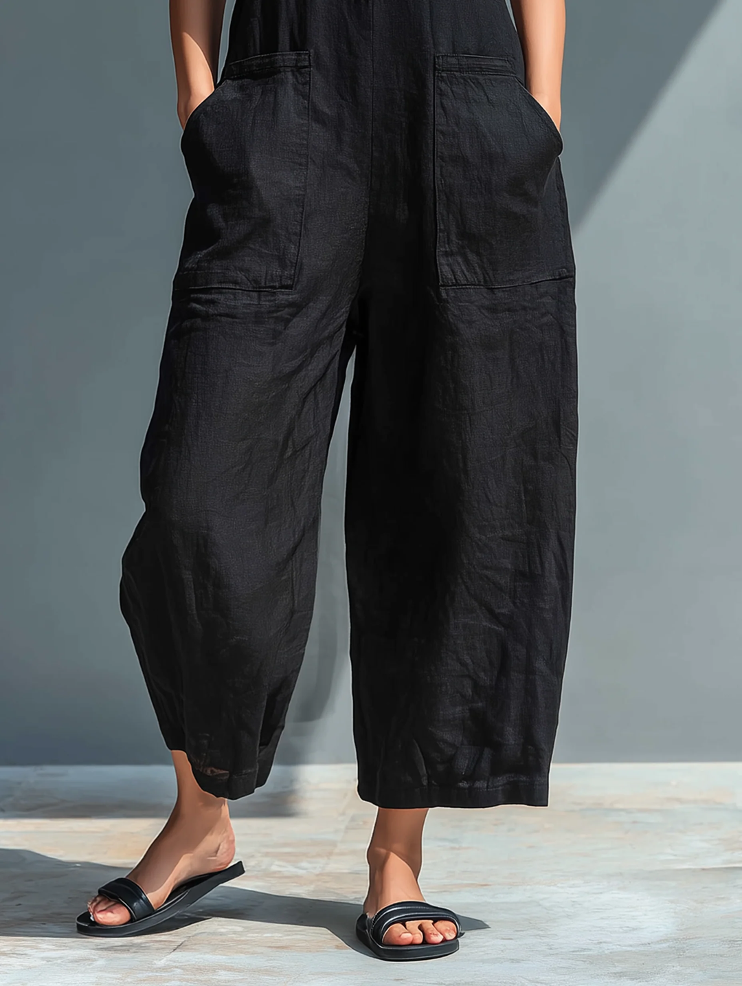 Stylish black sleeveless loose-fitting jumpsuit for women, offering comfortable and chic fashion for spring & summer.