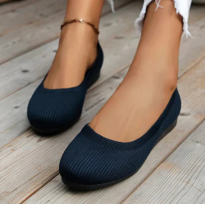 Side view of women's comfortable slip-on ballet flats with a flexible design.