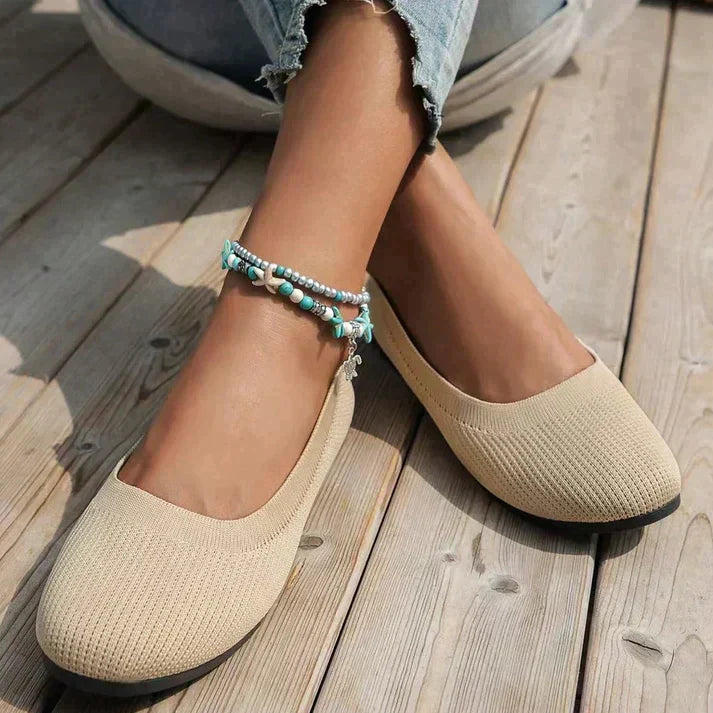 Classic black women's slip-on ballet flats, perfect for everyday comfort & style.